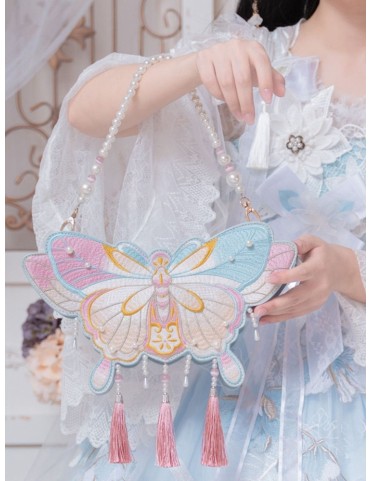 Sac brodé papillon à pompons rose et bleu