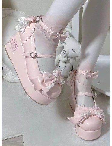 Plateformes roses en similicuir, ornées de nœuds et de dentelle